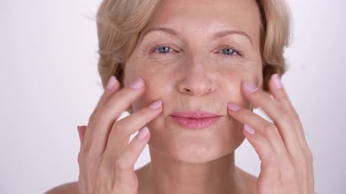 Elegant Woman Massaging Her Face with Care