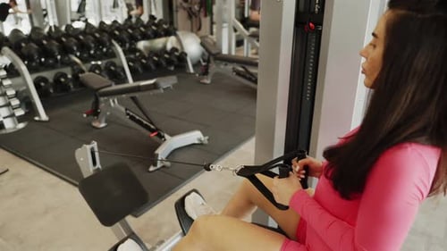 Woman in the Gym Working Out with Various Weights and Machines for Highperformance Training