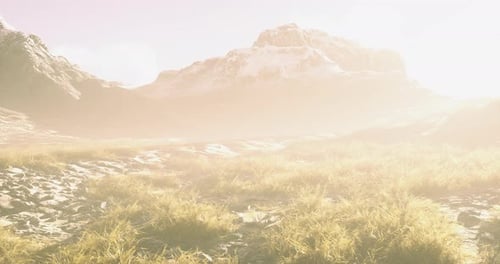 Mountain Landscape Bathed in Soft Light with Grass and Distant Peaks