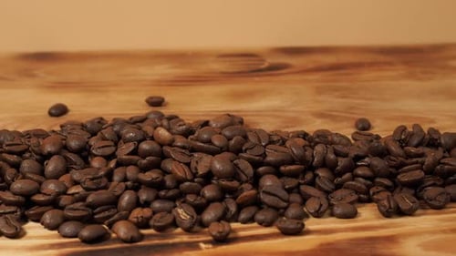 Roasted Coffee Beans with Cup on Wooden Table