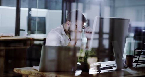 4k video footage of a handsome young businessman working in his office