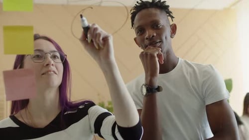 Black Man Dreadlocks in White Tshirt and a Woman with Purple Hair and Glasses are Jointly Planning