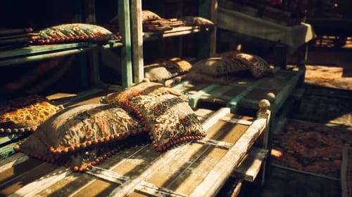 Decorative Cushions Placed on Rustic Wooden Shelves in a Market Setting