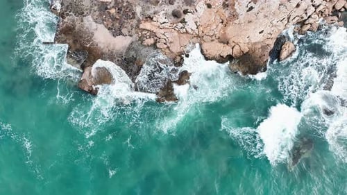Waves Crashing onto Rocky Coastline from Above