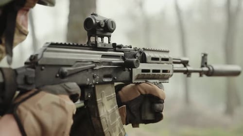 The Soldier Keeps His Finger on the Hook of the Machine Gun