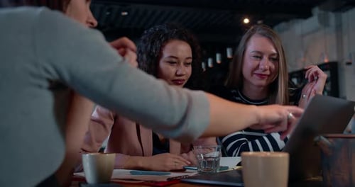 Young Caucasian Professional Female Coach Works with Beautiful Diverse Business Colleagues Points at