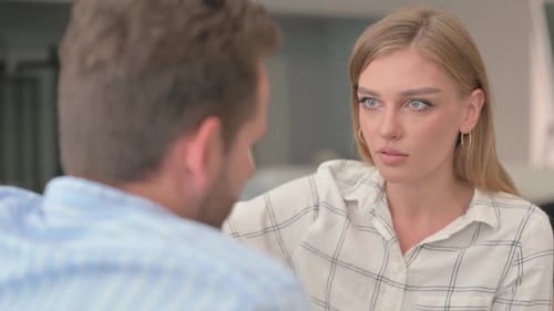 Woman Talking with Man in Home Setting
