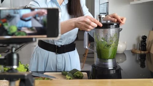 Woman Making a Green Smoothie in Kitchen