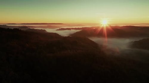 Aerial travelling Sunrise In A Misty Valley