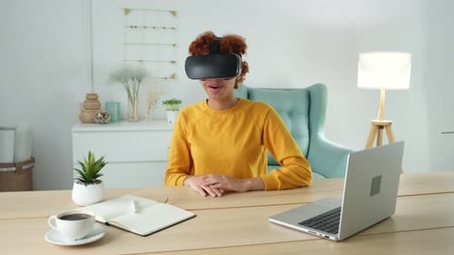 Young Woman Using VR Headset at Desk