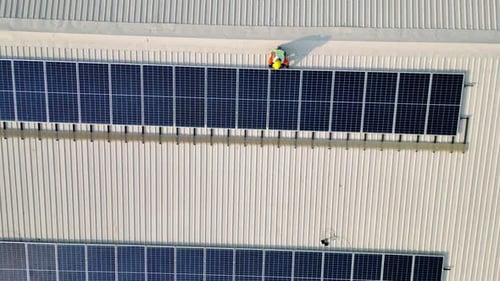 Solar energy and an engineering team on the roof of a building to install panel. Rooftop Solar cell.