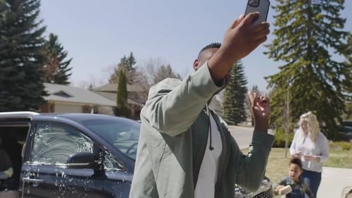 Family fun man captures car washing memories with a selfie on the driveway in Canada