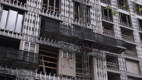 Primer plano del proceso de revestimiento de un edificio de varios pisos