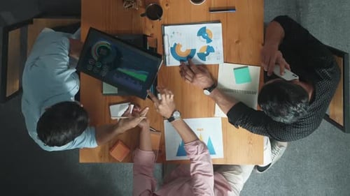 Top view of manager talking about financial graph to investors. Convocation.