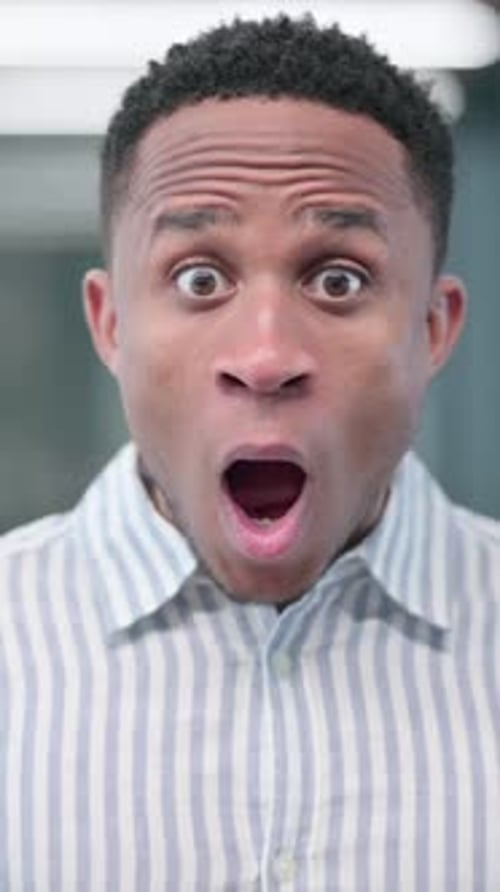 Man Displays Shocked and Overjoyed Expressions Close Up
