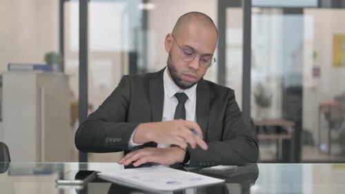 Man Signing Documents in an Office Environment