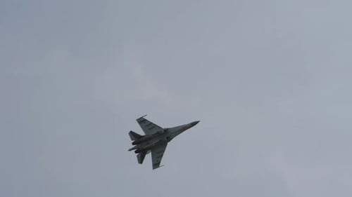 Impressive Military Fighter Jet Soaring Through Cloudy Sky