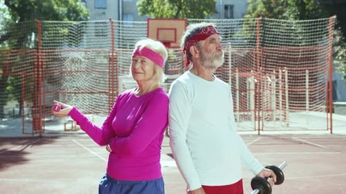 Active Senior Couple Exercising Outdoors in Sunlight
