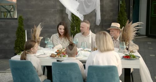 Family Meal at Decorated Outdoor Table