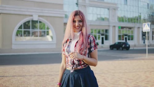 Portrait of a Young Beautiful Woman with Pink Hair on a European Street The Girl with Headphones