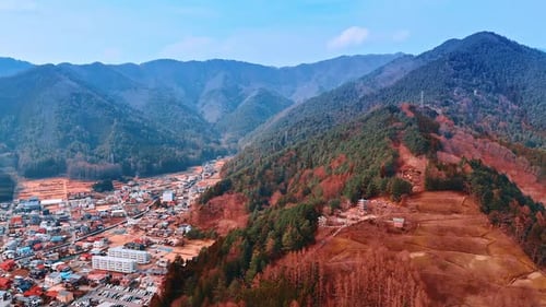 Pine tree woods covering the mountains that surround cityscape on Mount Fuji, Japan. Top view.