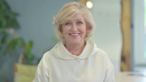 Portrait of Smiling Senior Old Woman Student Looking at Camera