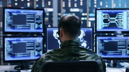 Back View of Military Technical Support Professional Giving Instructions Using Headset. He's Works