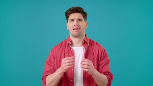 Young Man Covers Face with Palms Receiving Bad News