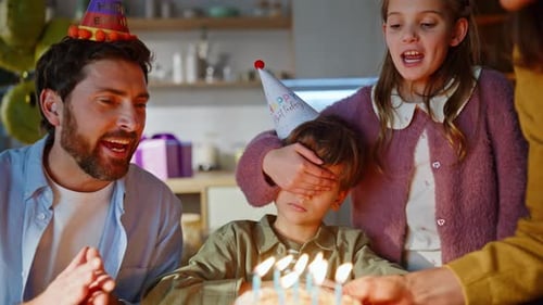 Happy Family Celebrating Birthday at Home with Cake