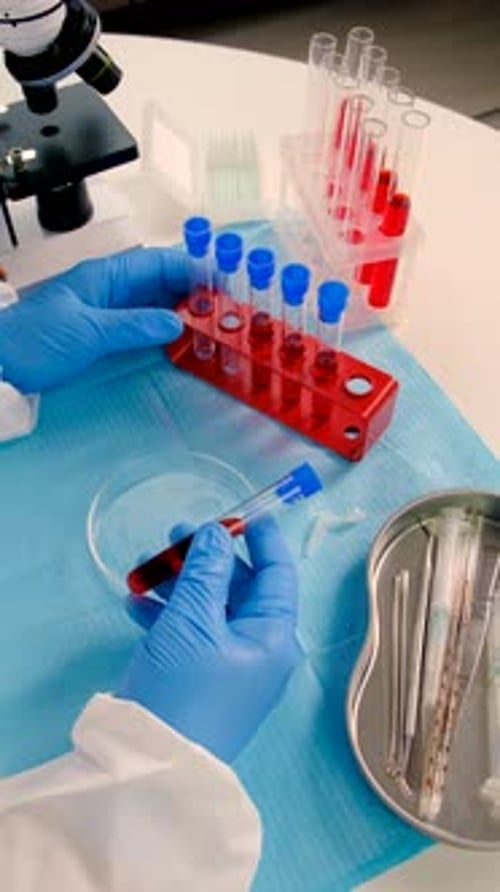 Medical Researcher Transfers Liquid from Test Tube