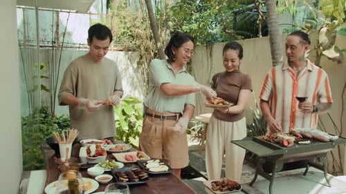 Friends Preparing Food on Grill Outdoors