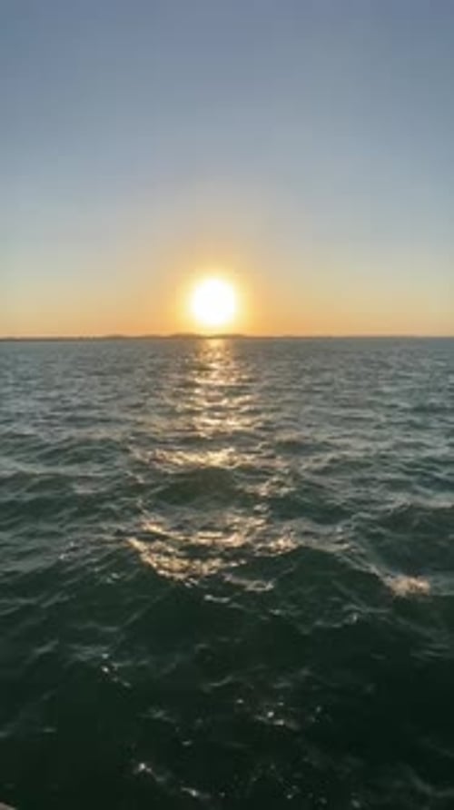 Tranquil Seascape Waves Gently Rolling in the Blue Ocean Under a Sky Dotted with Clouds Sunlight