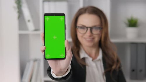 Chroma Key Template Green Screen on Smartphone Business Woman Holding and Showing Phone Screen on