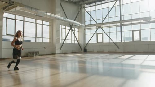 Pretty Sporty Woman in Her 30s Training Alone Indoors at Her Home Gym
