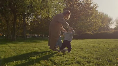 Mother helping her baby learning to walk in a park
