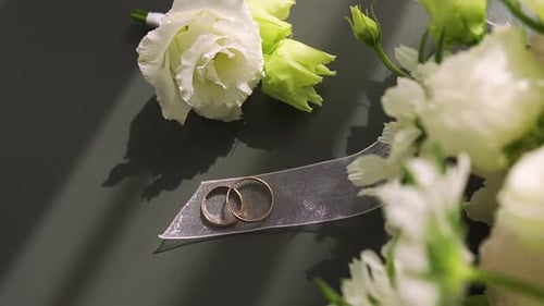 Wedding Rings on Silver Ribbon with White Flowers