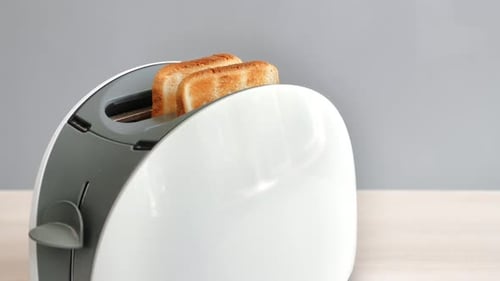 Crispy Toast Popping Out of a Modern Toaster