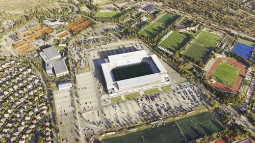 Wide drone panorama of Claro Arena stadium and the surrounding athletic tracks and educational