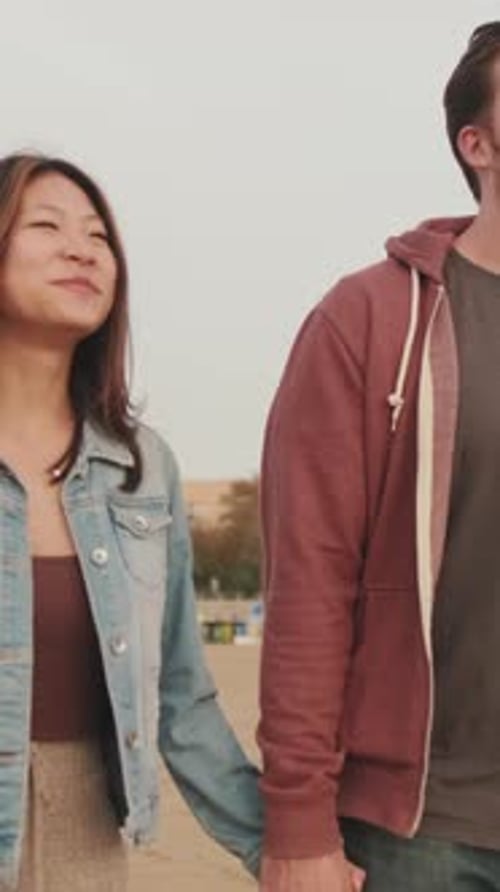 Young couple walking along the beach