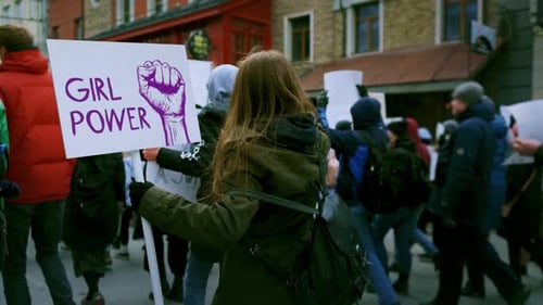 People Protesting with Signs on City Street