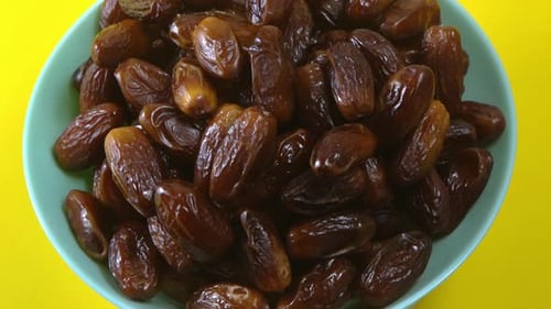 Bowl of Fresh, Glossy Dates Close-Up