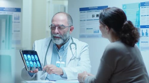Doctor Showing Medical Scan to Patient on Tablet