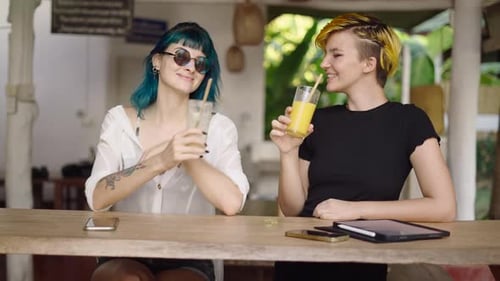 Happy Coworkers Cheer with Juice Beverages at Hotel Bar Terrace After Work Slow Motion Shot