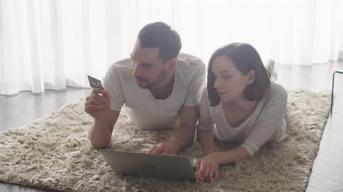 Couple Shops Online With Laptop at Home