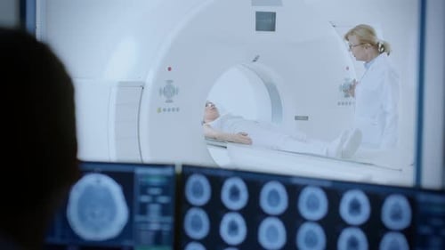 In Medical Laboratory Patient Undergoes MRI or CT Scan Process under Supervision of Radiologist, in