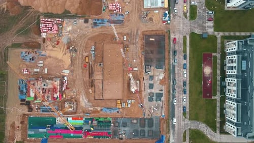 Construction Site with Cranes and Foundations Under Construction Aerial View