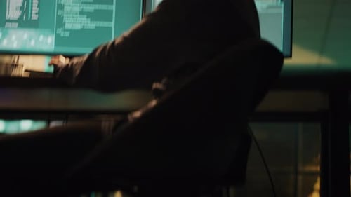 Two People Programming Computer Code at Night