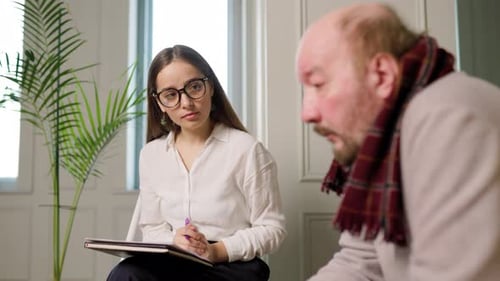 Woman Listening to Man in Bright Indoor Setting