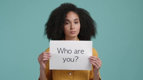 Woman Holding "Who Are You?" Sign