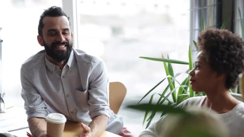 Colleagues Enjoying a Conversation in a Bright Office